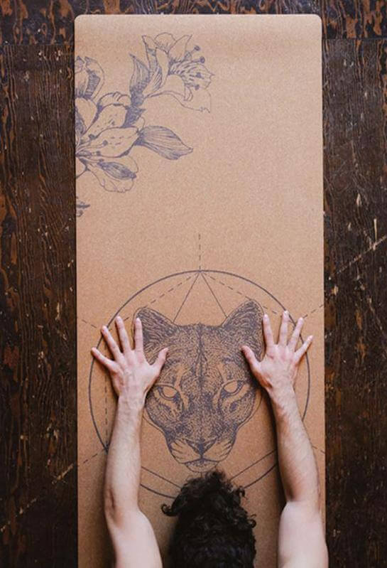 hands in childs pose on Scoria Mountain Lion cork mat