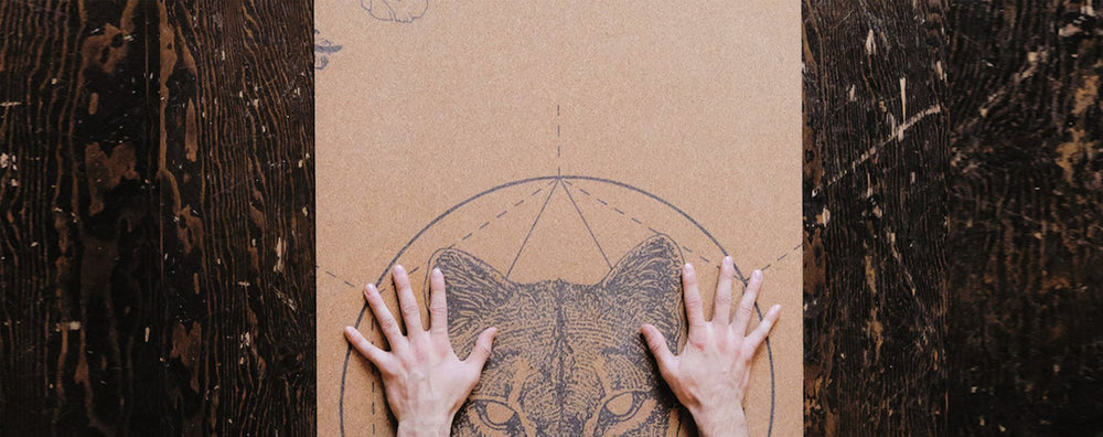 hands in childs pose on Scoria Mountain Lion cork mat